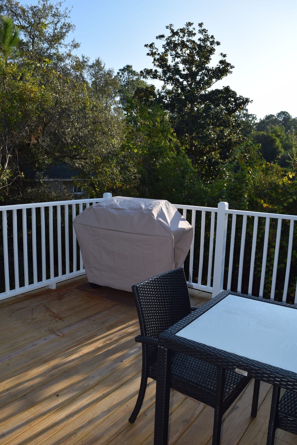 Back deck complete with propane grill and bistro table.
