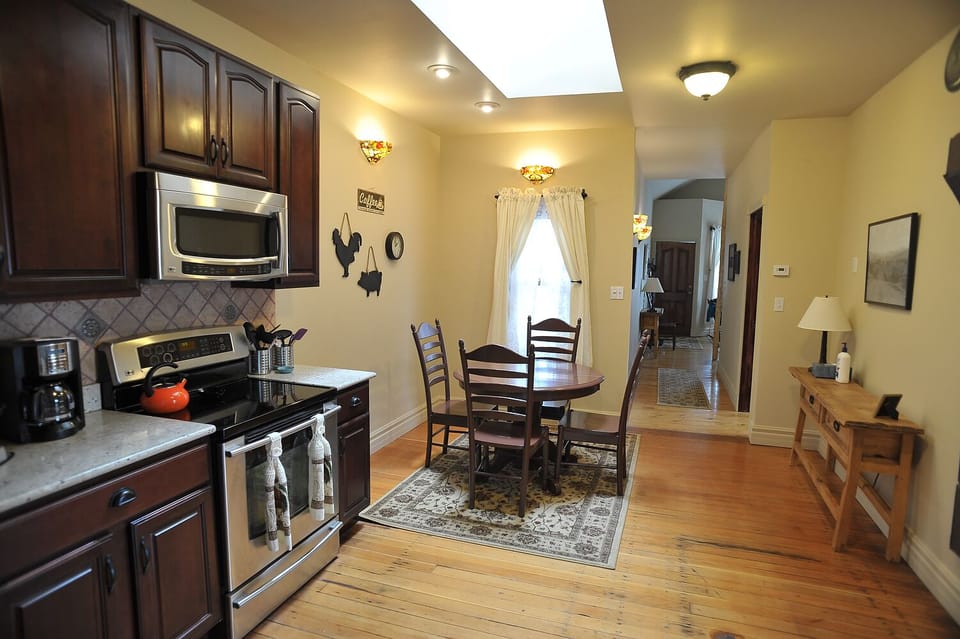 Large eat-in kitchen lit up by the huge skylight.