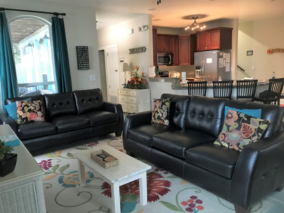 Family room with leather couches, smart tv and blu ray player.