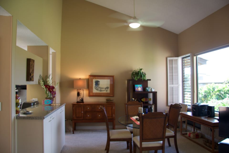 Dining room just off of the kitchen, with ceiling fan and light.