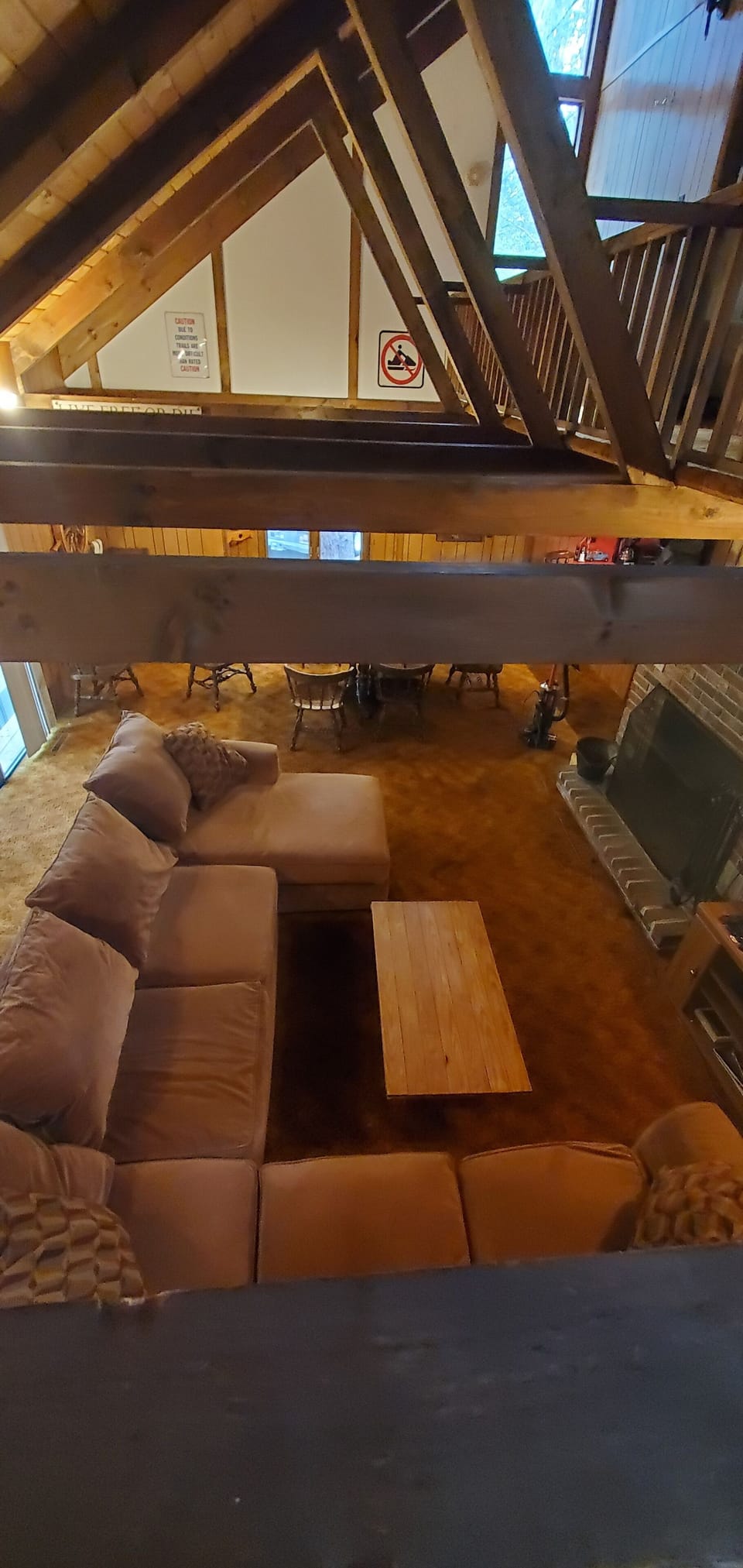Open concept living room, high ceilings, flat screen TV, fireplace. 