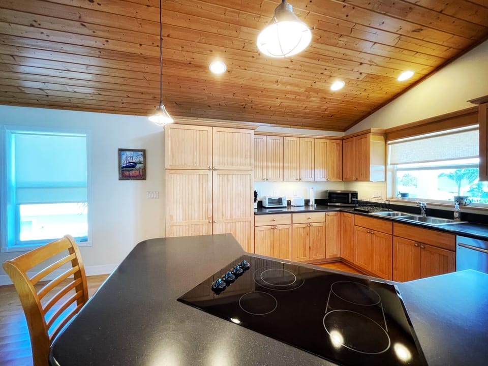 Hardwood cabinets, floors and ceiling. Well equipped kitchen.