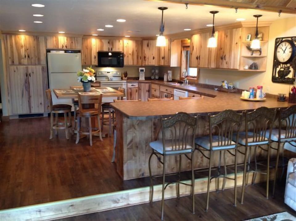 Large modern kitchen with seating for a dozen people.