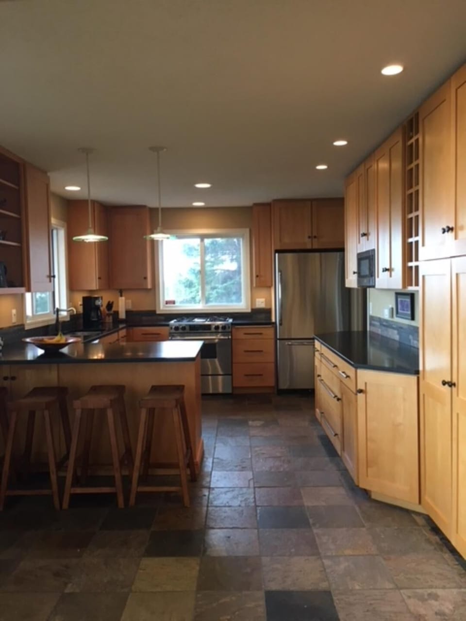 Clean-line birch cabinetry, honed granitecountertops, penninsula with 4 stools.
