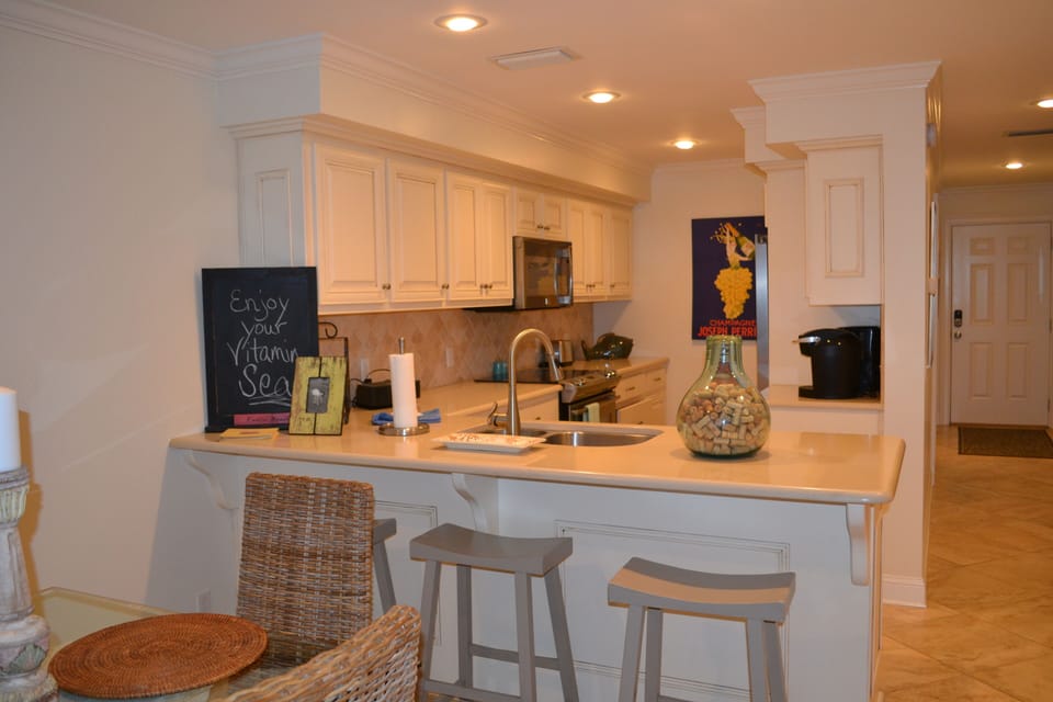 Looking into kitchen.  Work at sink and look out at the ocean.
