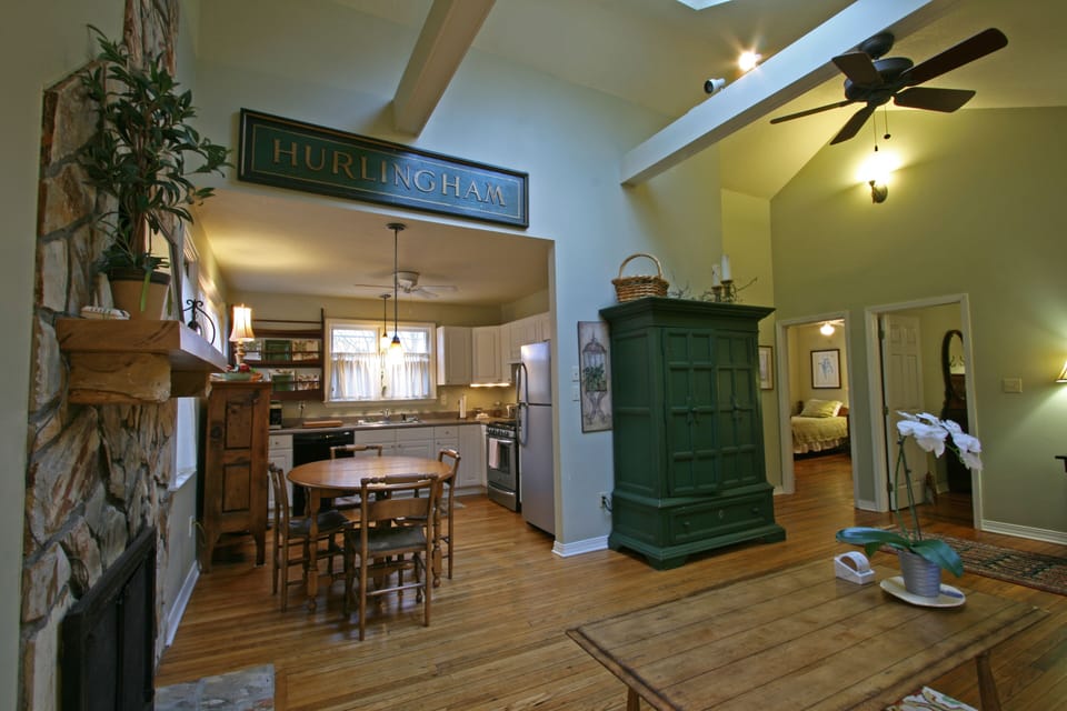standing in front of french doors, looking toward kitchen, and bedrooms to right