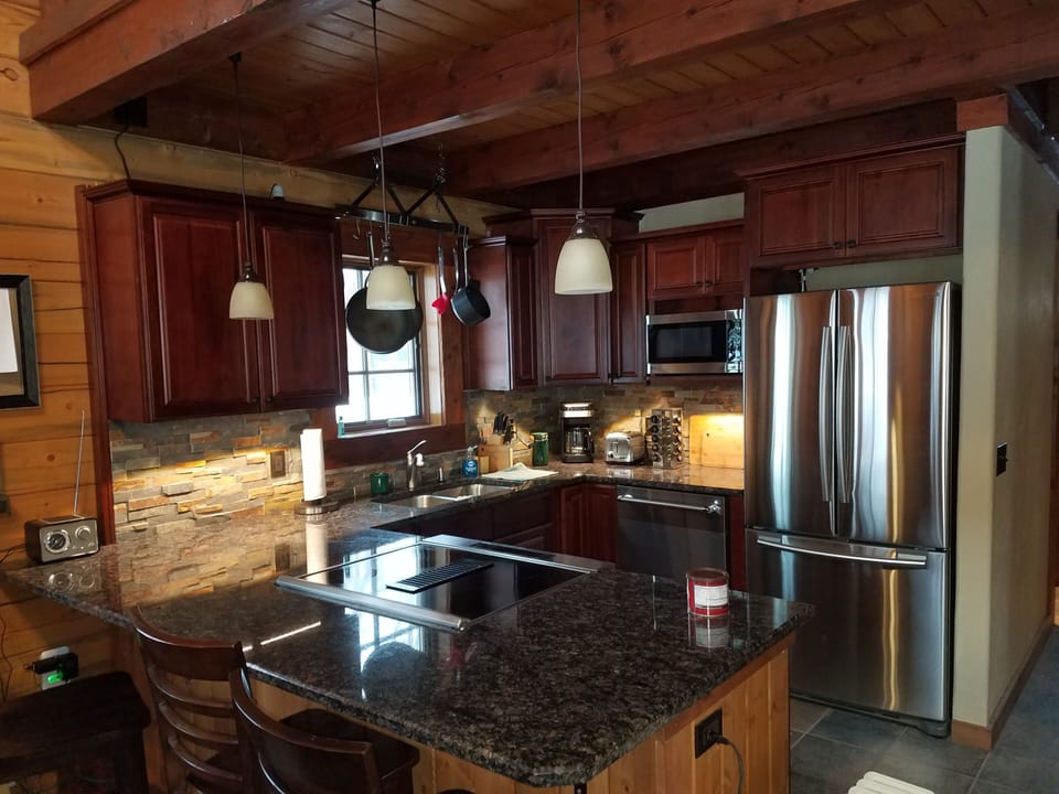 Stainless steel KItchen Aid stove and granite countertops.