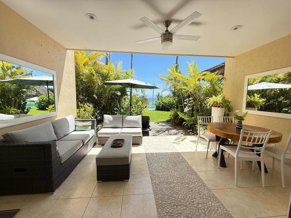 Spacious living area with direct access to the private terrace, creating a seamless indoor-outdoor space perfect for relaxing and enjoying the tropical breeze.
