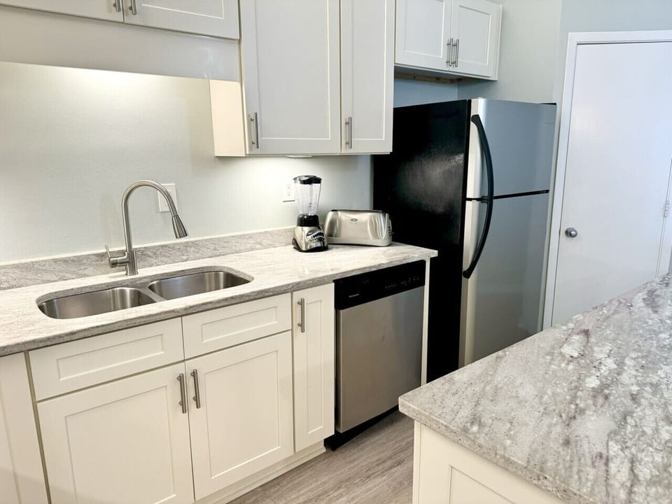 Kitchen with stainless steel appliances. Double sink makes dish washing easy!