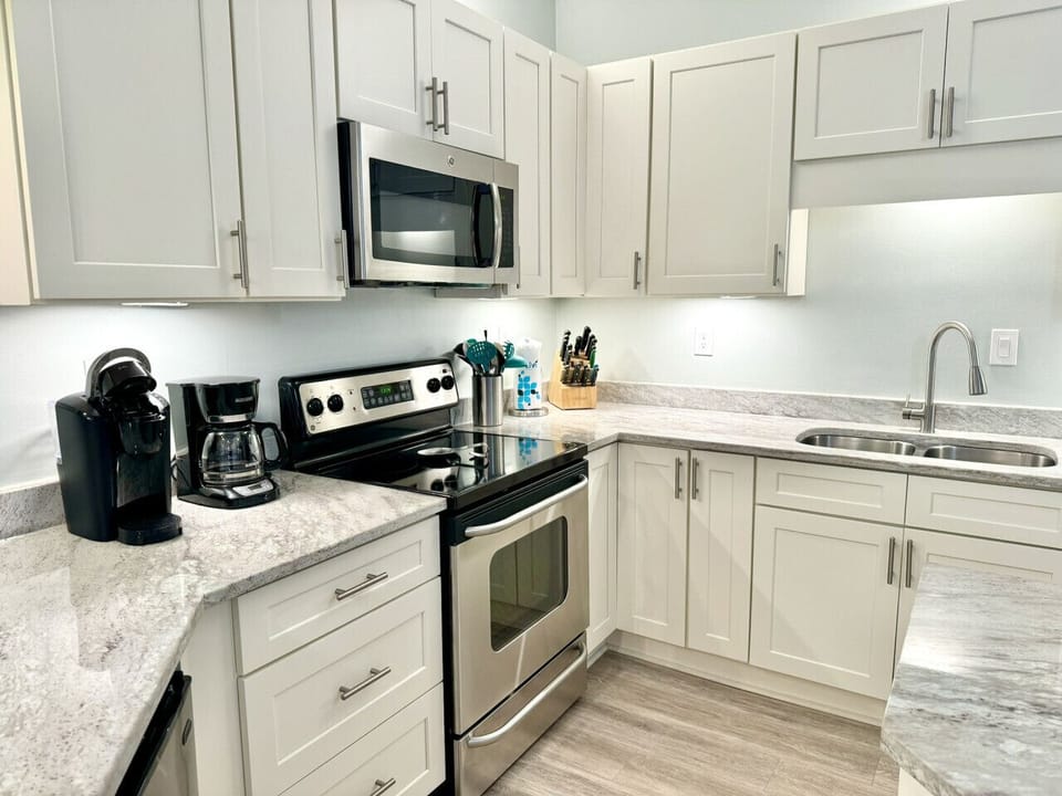 Plenty of dishes, cups, and silverware located in the many cabinets
