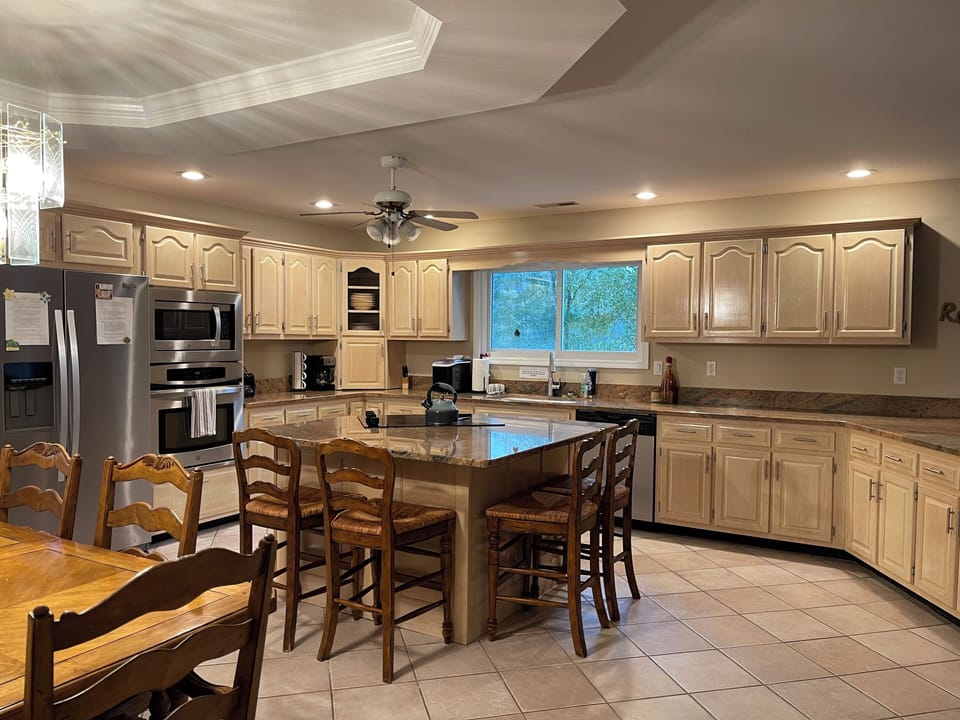 Island seating for 4 in kitchen along with 6 person dining room table.