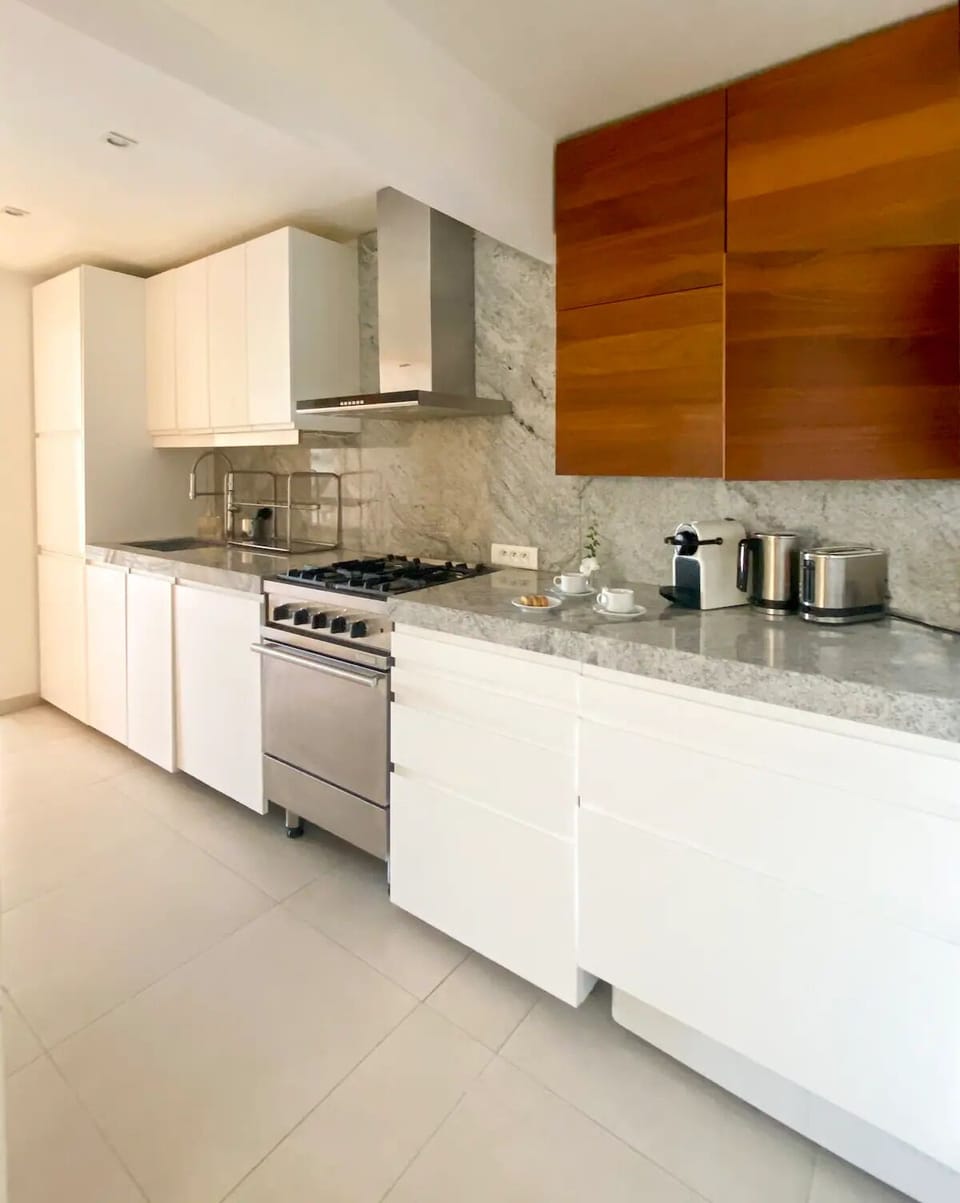 the fully equipped granite counter kitchen 
