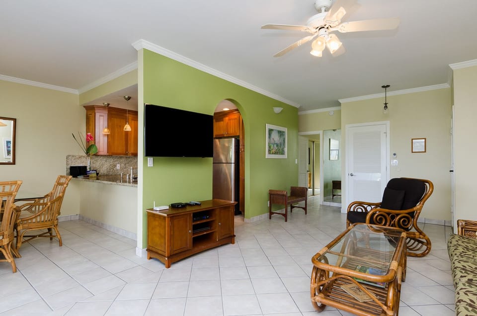Large wall mounted smart tv and view from the dining to the kitchen, dining