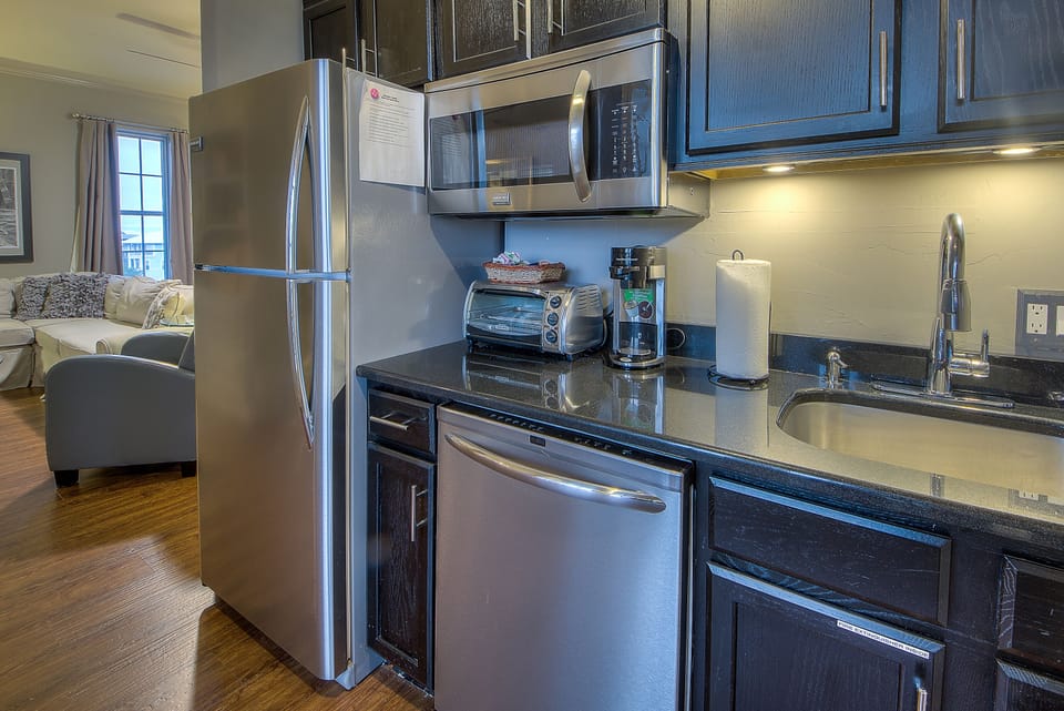 Well-equipped compact kitchen with full size fridge and ice maker
