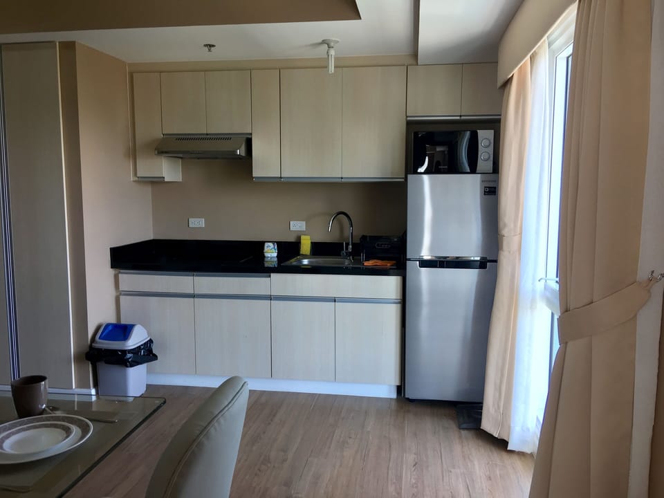 Kitchen equipped with built in glass top induction stove, microwave, etc.   