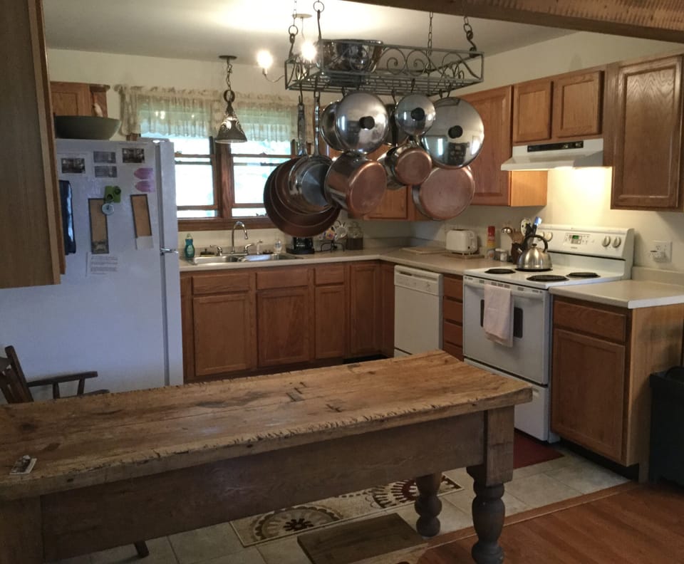 Antique butcher block, hanging pot rack as you enter the kitchen.
