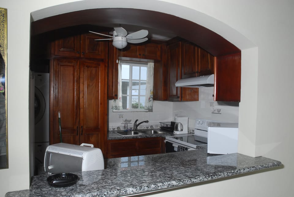 View of granite top kitchen serving alcove facing dining room!