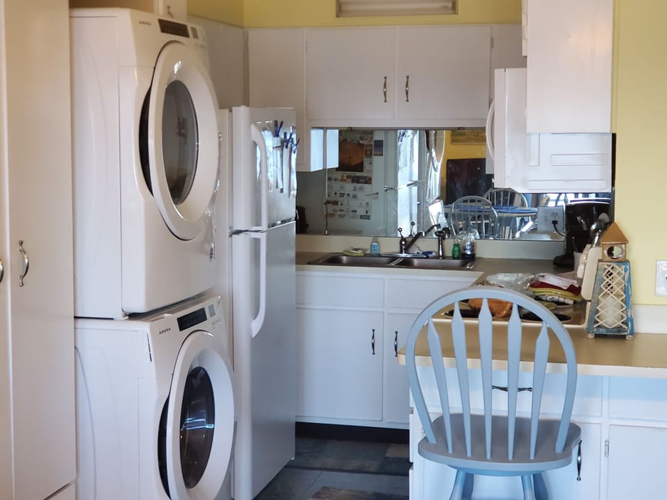 Kitchen area with appliances needed for cooking or storing things to keep cold