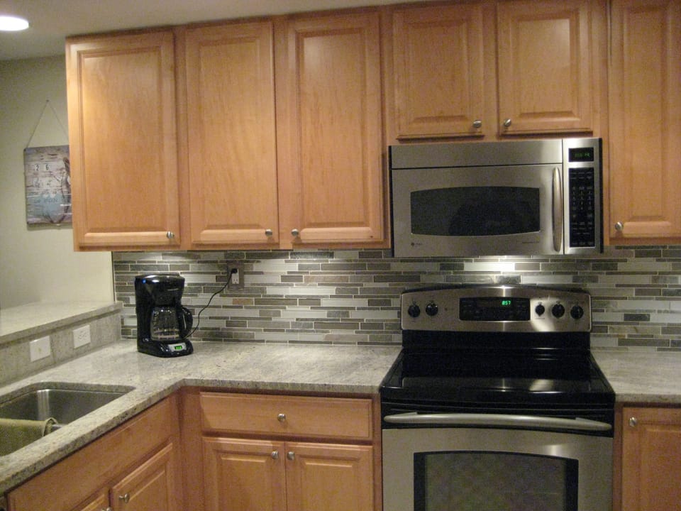 Granite countertops and stone tile backsplash!