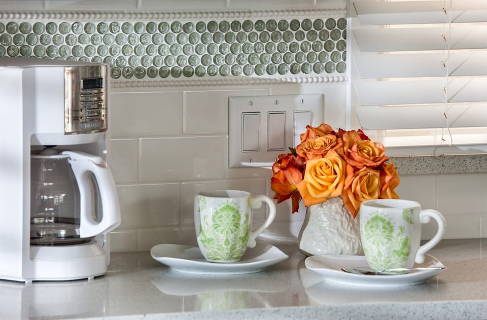 Kitchen closeup of beautiful tile back splash and quartz counter top.