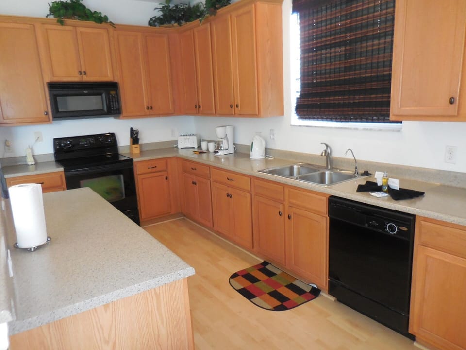 Another kitchen view, dishwasher, microwave, coffee machine etc