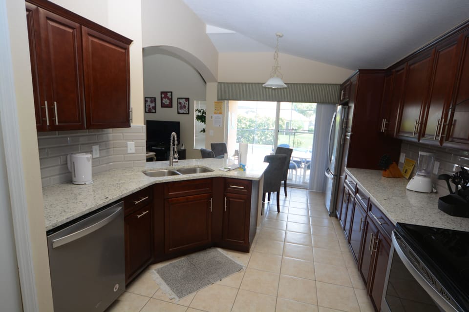 kitchen looking onto nook and pool patio