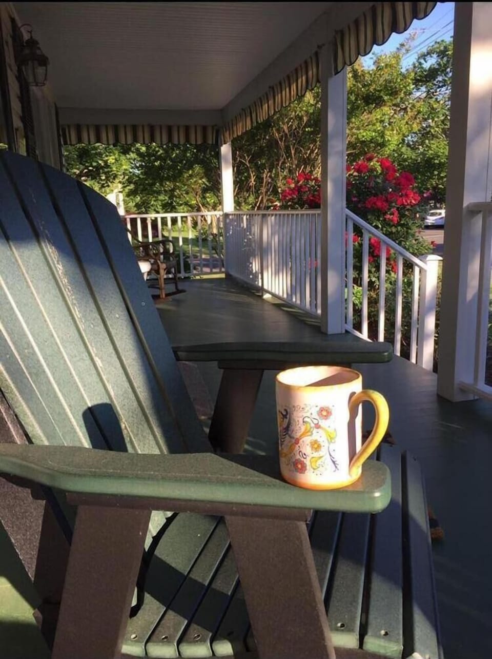 front porch with comfortable, adirondack seating