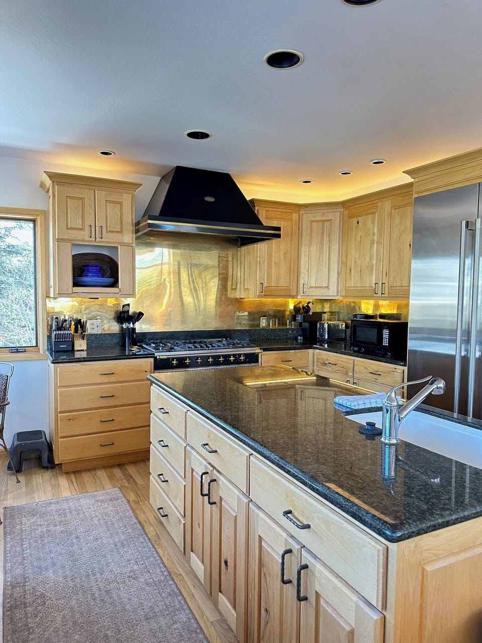 Fully equipped kitchen with granite counters and generous prep space
