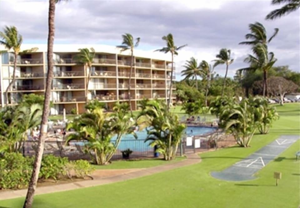 View beautiful grounds, pool and shuffle board from Lanai