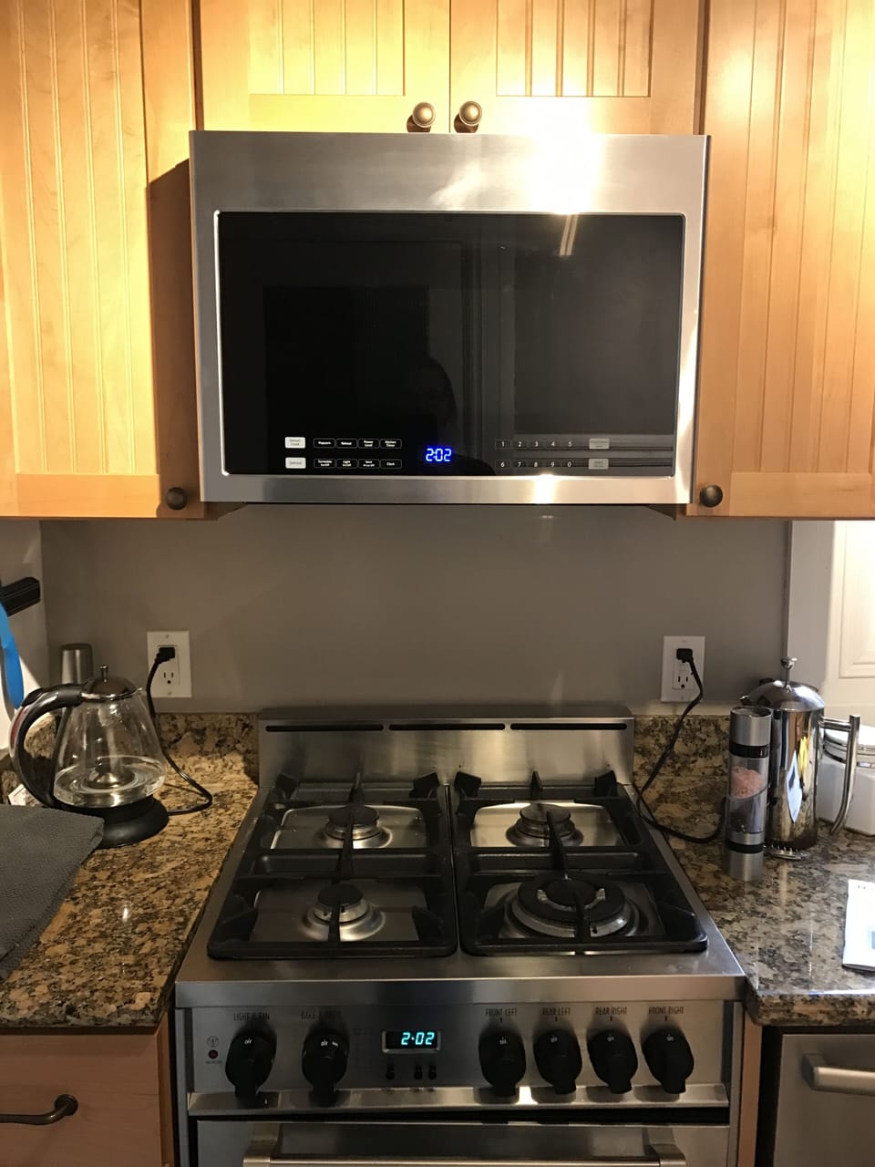Gas range and microwave oven.  Kitchen appointed with Williams and Sonoma Pans