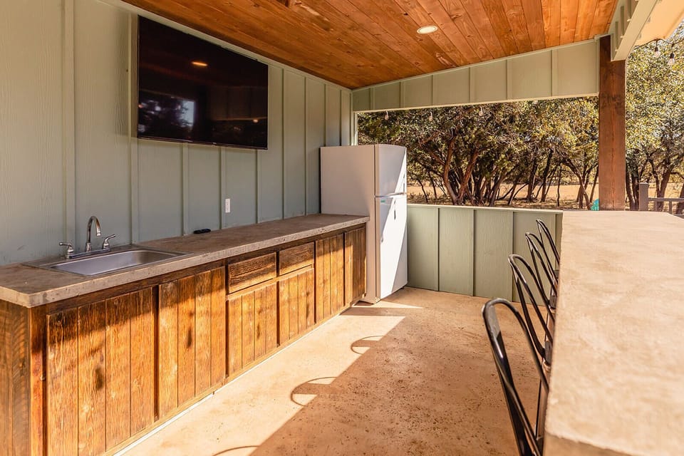 Additional full size fridge in outdoor kitchen. 