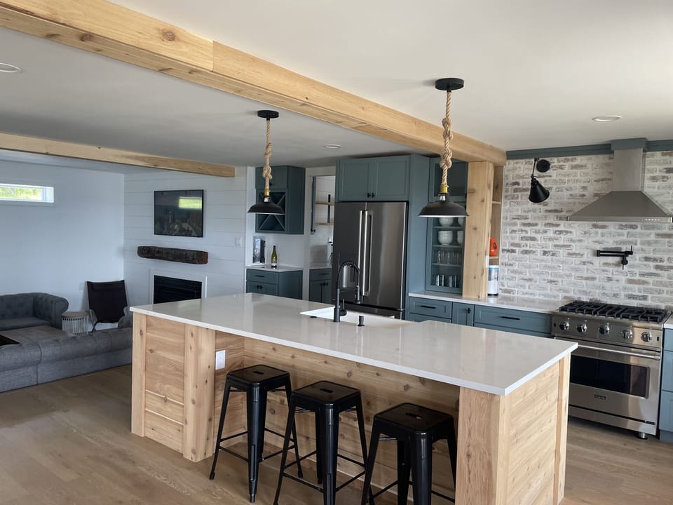 Kitchen with expansive island. All standard appliances plus a beverage fridge. 