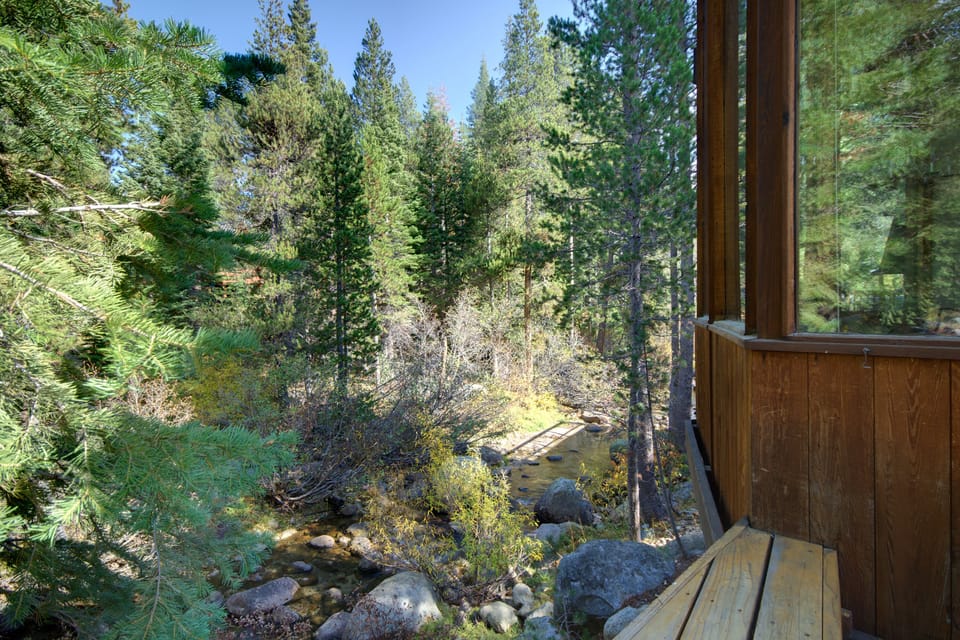 View from the long deck bench to Squaw Creek. Outdoor table and La Fuma chairs.