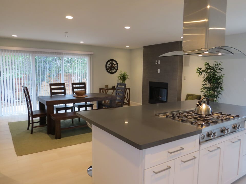 Kitchen with 4 barstools and dining area