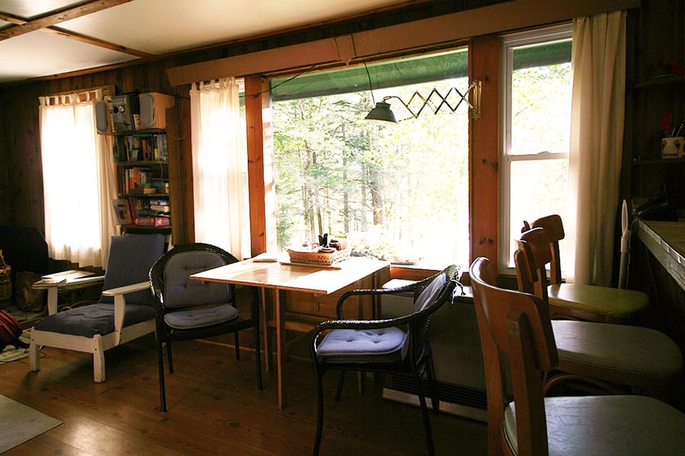 living room looking out picture window with a view of the water