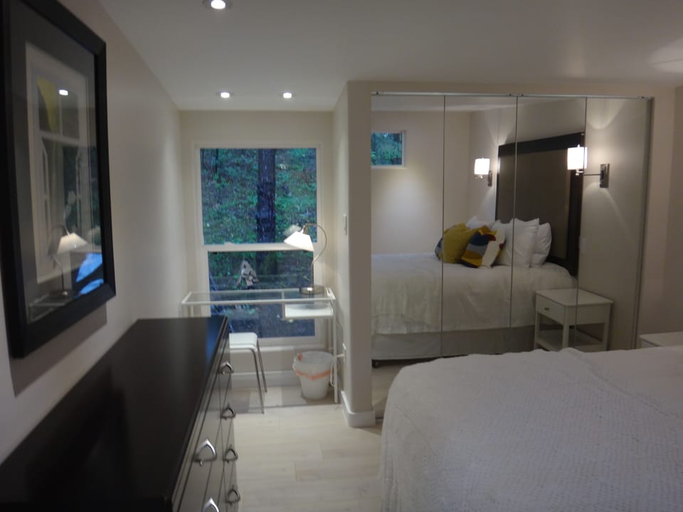 Luxury bedroom with desk overlooking the trees