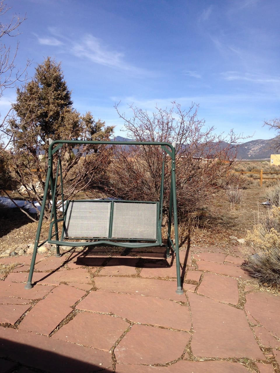 Freestanding porch swing near patio