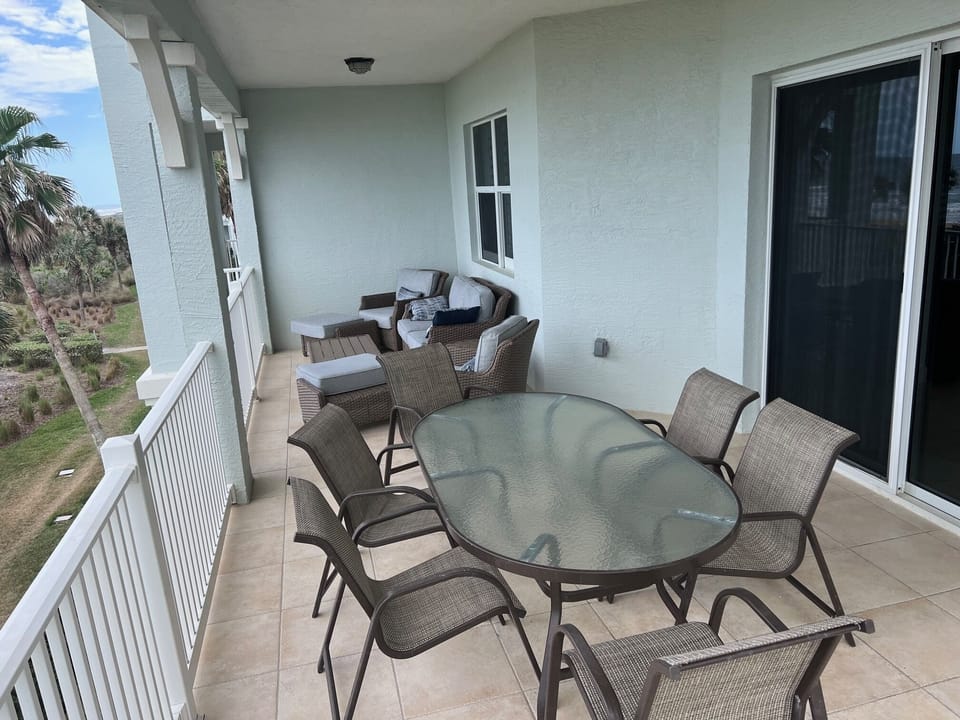 Large balcony open on three sides to the oceanfront view.