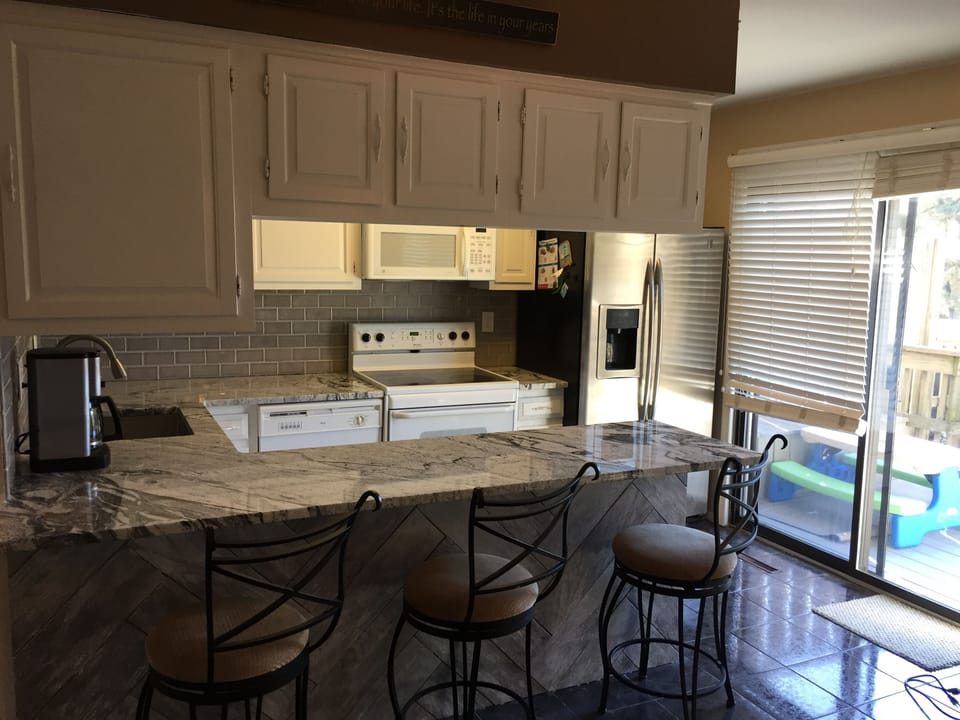 Kitchen looking in from dining room - new counter top and tile backsplash