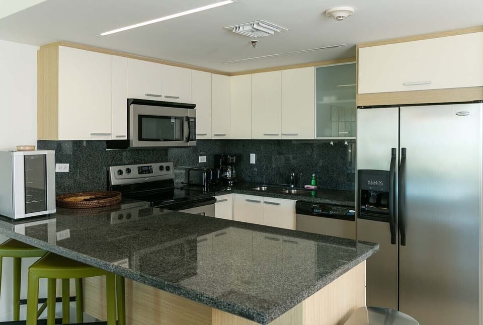 Your fully equipped kitchen features modern stainless steel appliances, sleek granite countertops, and ample storage—perfect for preparing fresh meals during your getaway.