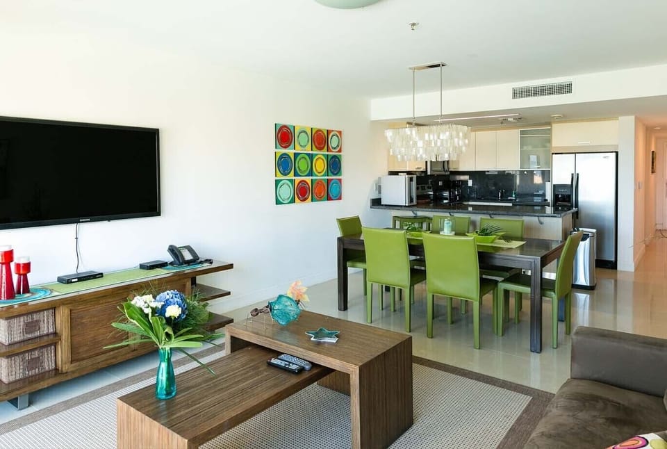 Your bright, modern space flows seamlessly from living room to kitchen, perfect for gathering around the dining table or relaxing after a day of exploration.