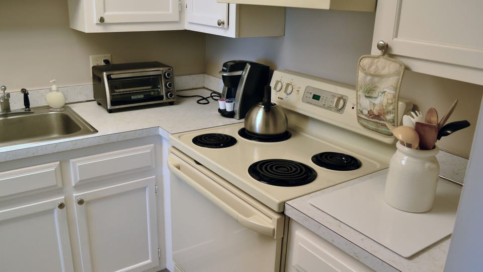 Full size stove/oven, refrigerator, microwave, toaster, coffee maker, blender