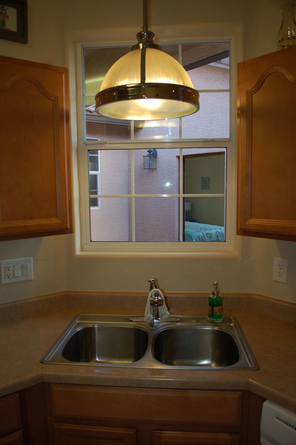 At the kitchen sink, looking across the courtyard to the entry of the Casita.