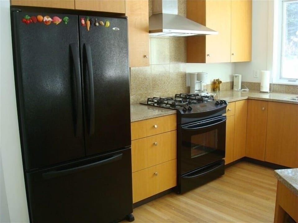 Modern, gourmet kichen, window looks on to garden.  Laundry room is next room.