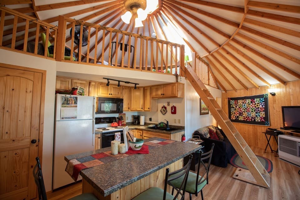View of main living area, kitchen with island seating, and loft