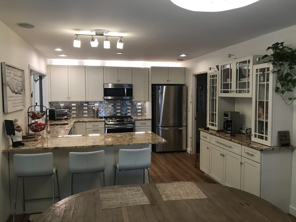 Open floorplan kitchen with eating peninsula, coffee station, and dining area.