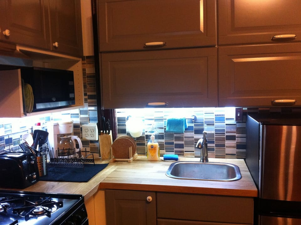stove, kitchen sink and cabinets