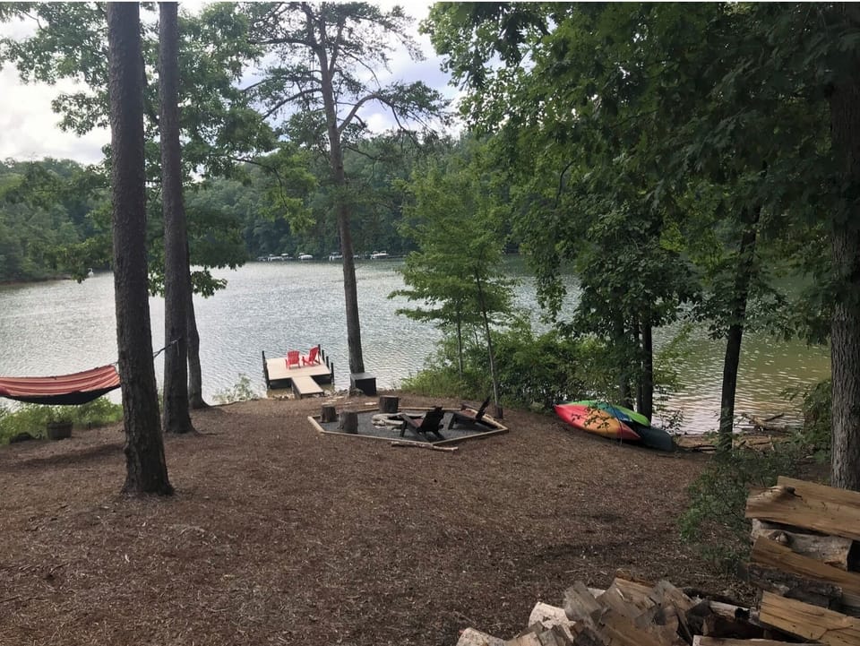 Lake area with hammock, fire pit, kayaks, and canoe. Deep water dock. 