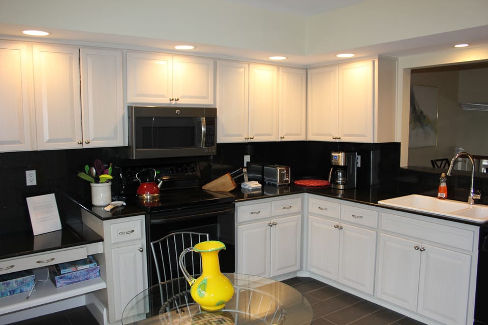 Kitchen offers refrigerator with icemaker, stove, microwave and extra large sink