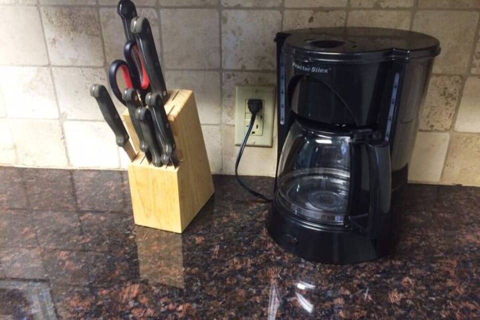 fully equipped kitchen including stove, oven, microwave, utensils, pots and pans